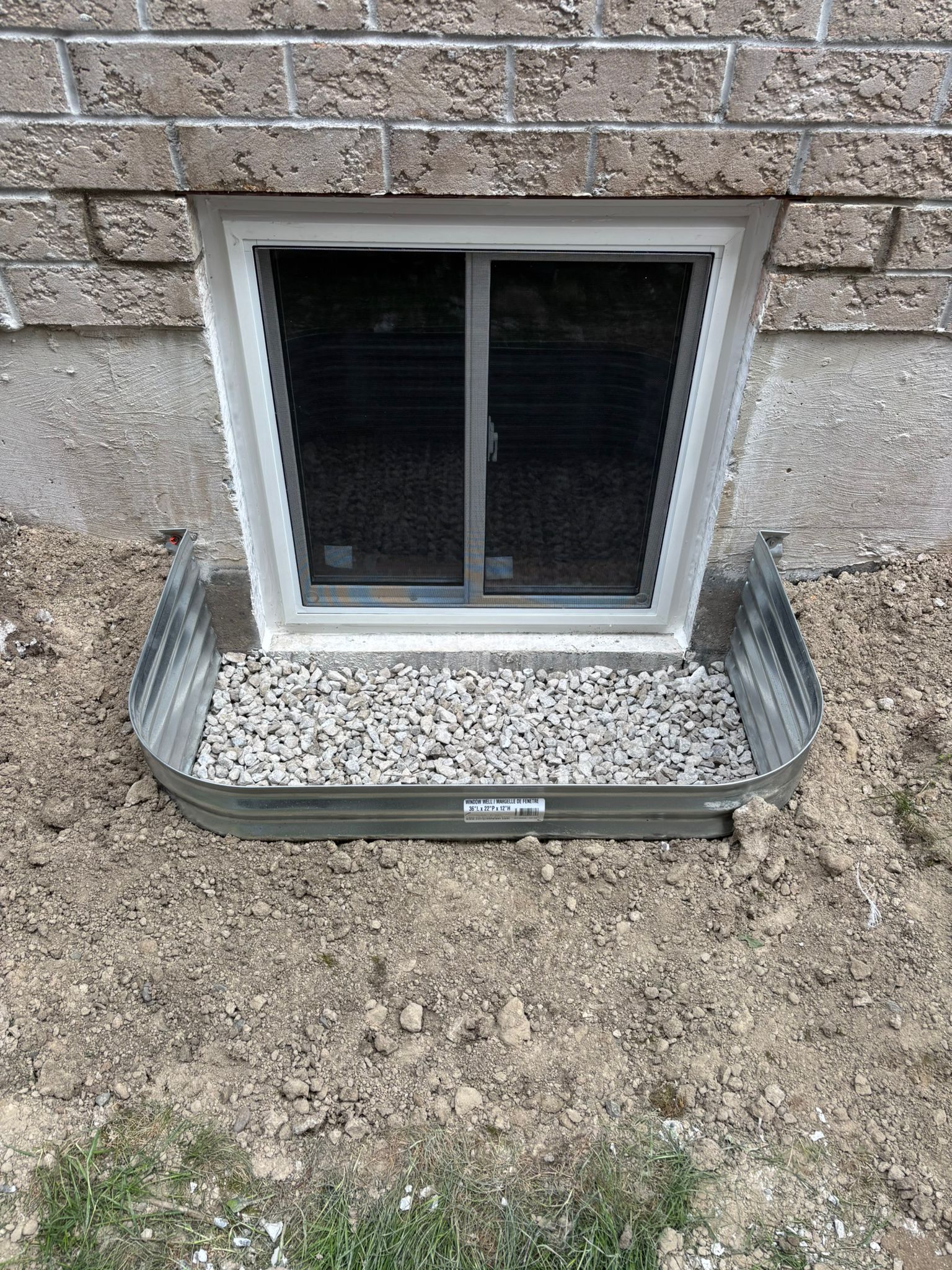 New basement window with window well installation