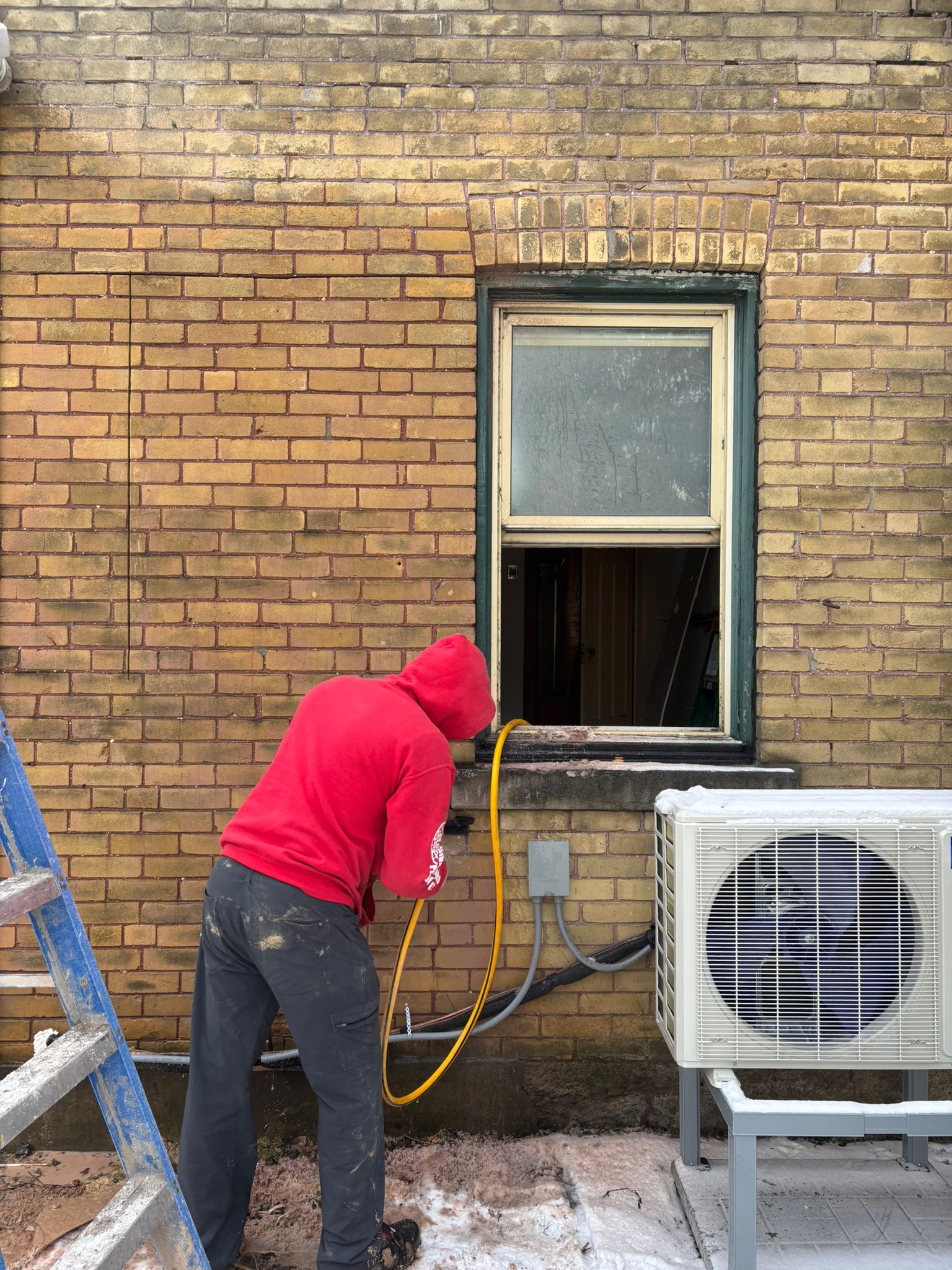 Express Windows installer at work on a brick home